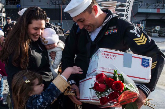 141219-N-MN975-033  EVERETT, Wash. (Dec. 19, 2014) A Sailor assigned to the Oliver Hazard Perry-class guided-missile frigate USS Rodney M. Davis (FFG 60) greets his family on the pier after completing a six-month deployment. Rodney M. Davis returns from its final deployment to the Pacific and Indian Ocean. (U.S. Navy photo by Mass Communication Specialist 2nd Class Justin A. Johndro/Released)