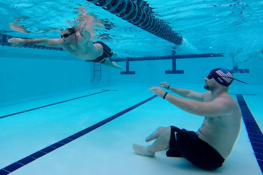 150310-N-DT805-113 Joint Base Pearl Harbor-Hickam (Mar 10, 2015) Navy Safe Harbor Wounded Warrior Brett Parks observes Redmond Ramos as he participates in Pacific Trials swimming practice at Joint Base Pearl Harbor-Hickam. The trials allow wounded, ill and injured Sailors and Coast Guardsmen from across the country to compete in cycling, seated volleyball, swimming, track and field, and wheelchair basketball at JBPHH and other locations throughout the island. The top 40 athletes will be awarded a spot on Team Navy and advance to a competition among all branches of the military. (U.S. Navy photo by Chief Mass Communication Specialist John M. Hageman/Released)