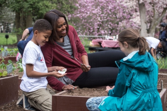 First Lady Michelle Obama joins students for the spring garden planting in the White House Kitchen Garden, April 15, 2015. (Official White House Photo by Chuck Kennedy)
