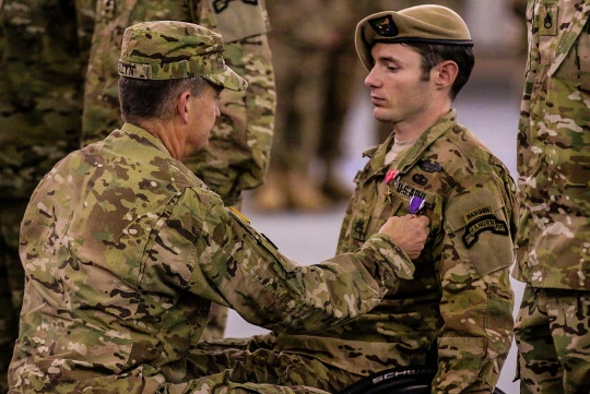 Gen. Daniel B. Allyn, vice chief of staff of the United States Army, presents Sgt. Travis Dunn, Ranger squad leader, with the Bronze Star Medal for Valor and the Purple Heart. Dunn was wounded while conducting combat operations in Nangahar province, Afghanistan, Dec. 2. Dunn maneuvered on multiple enemy fighting positions over a sustained six-hour direct fire engagement resulting in the elimination of more than 25 enemy combatants. Without regard for his own personal safety, he closed with an armed enemy in both a close ambush and on three barricaded shooters. Dunn's poise while under direct fire undoubtedly saved the lives of numerous Rangers and directly contributed to the success of the joint task force. (U.S. Army Photo by Pfc. Eric Overfelt; 75th Ranger Regiment documentation specialist/Released)