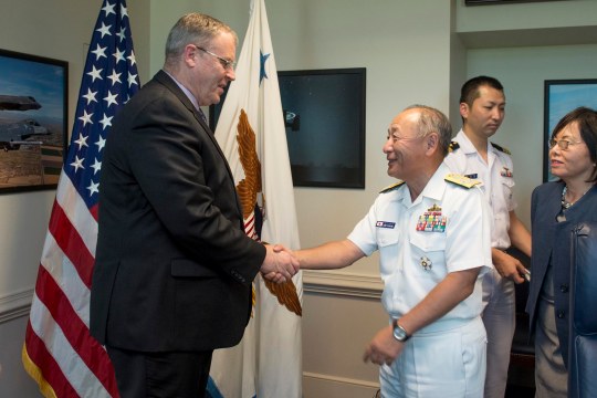 U.S. Deputy Defense Secretary Bob Work, left, greets Japanese Adm. Katsutoshi Kawano, chief of the joint staff for Japan Self-Defense Forces, as he arrives at the Pentagon, July 16, 2015. The two leaders met to discuss matters of mutual importance.