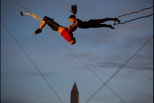 Oliver Parkinson and Lizzy Schwartz rehearse on a trapeze on the South Lawn, Oct. 29, 2015. They will be performing with other aerialists during the White House Halloween celebration Friday. (Official White House Photo by Pete Souza)
